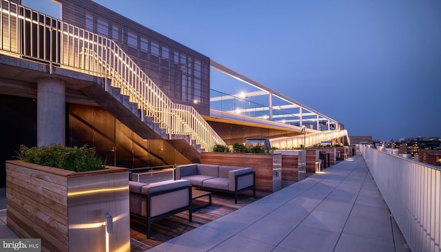 patio terrace at dusk featuring outdoor lounge area