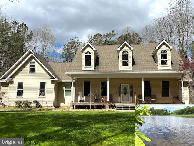 new england style home featuring a porch and a front yard