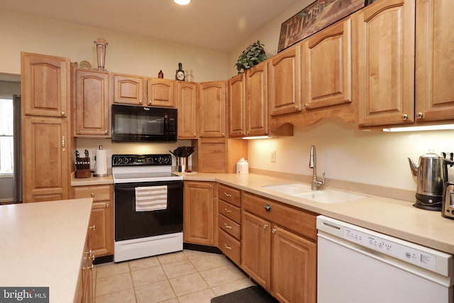 kitchen featuring sink, light tile patterned flooring, and white appliances