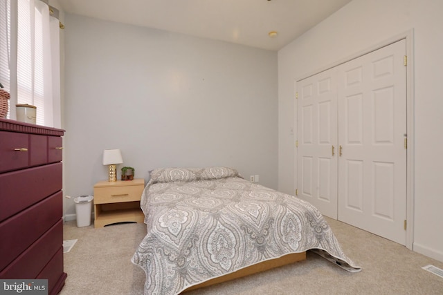 carpeted bedroom featuring a closet