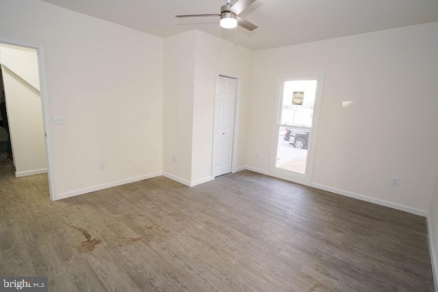 spare room featuring ceiling fan and dark hardwood / wood-style flooring