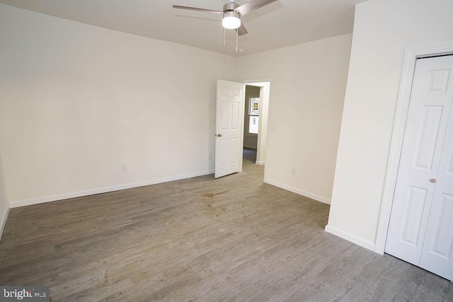 spare room with hardwood / wood-style flooring and ceiling fan