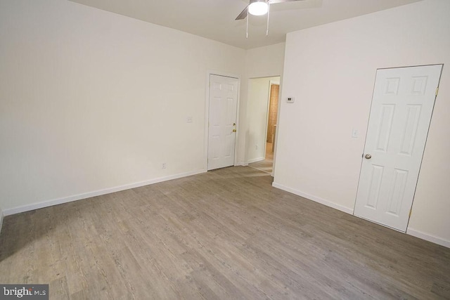 unfurnished room featuring ceiling fan and hardwood / wood-style floors