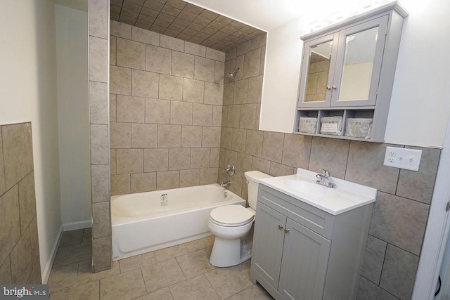 full bathroom with toilet, decorative backsplash, vanity, tile walls, and tiled shower / bath