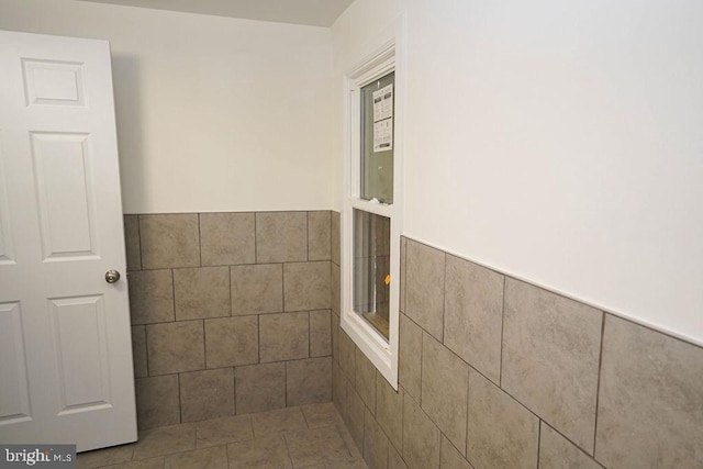 bathroom with tile walls