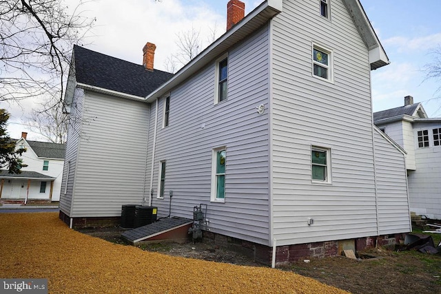 rear view of property featuring central AC unit