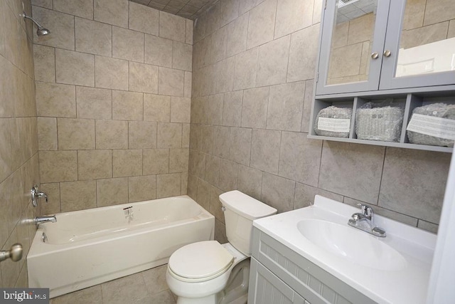 full bathroom with tiled shower / bath combo, tasteful backsplash, toilet, vanity, and tile walls