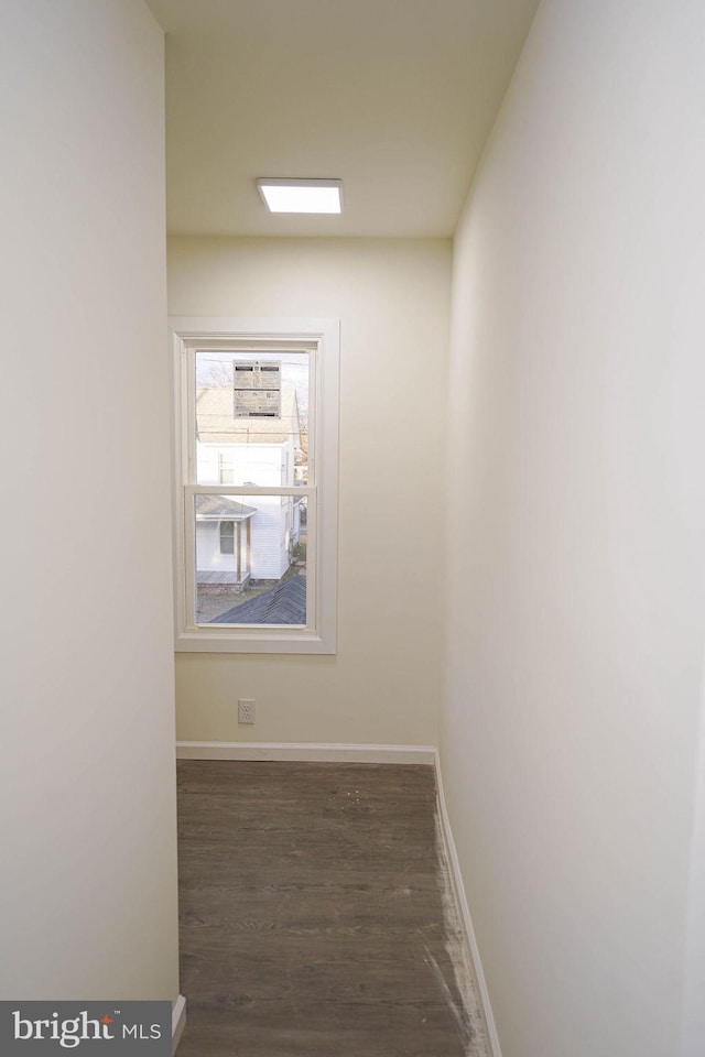 hallway with dark wood-type flooring