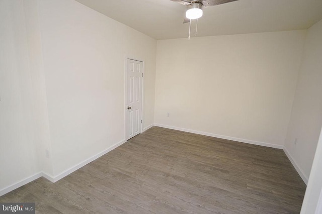 empty room with ceiling fan and dark wood-type flooring