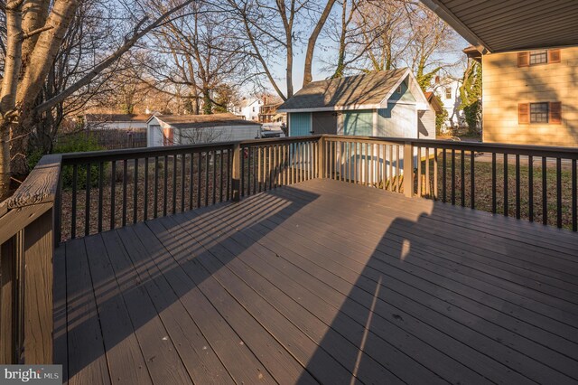 wooden terrace featuring a storage shed