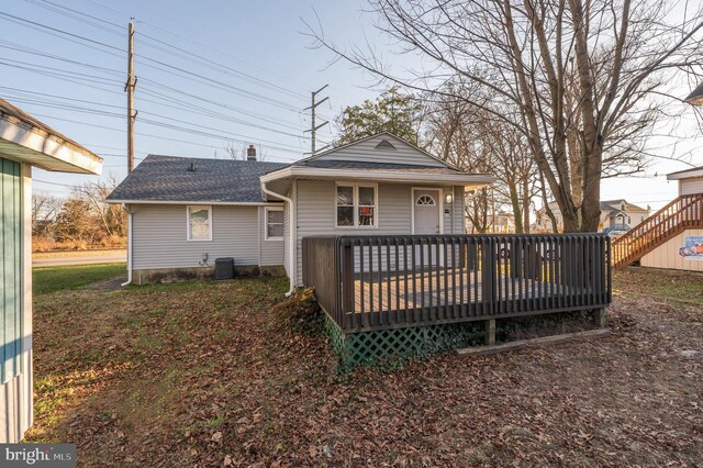 rear view of property with a deck and central AC