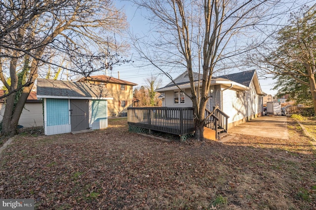 view of yard with a wooden deck and a shed