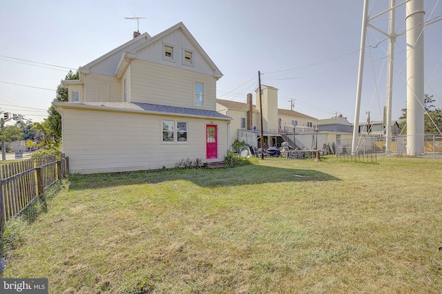 rear view of house with a yard