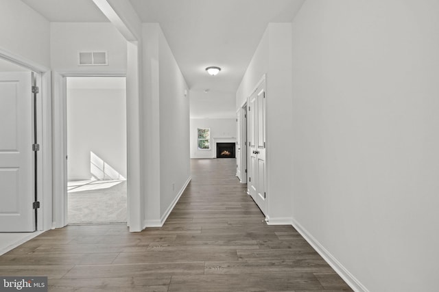 corridor with dark hardwood / wood-style floors