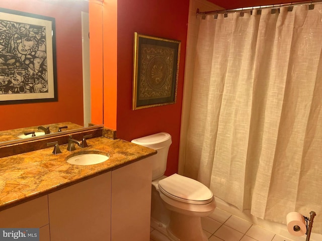 bathroom with vanity, tile patterned flooring, and toilet