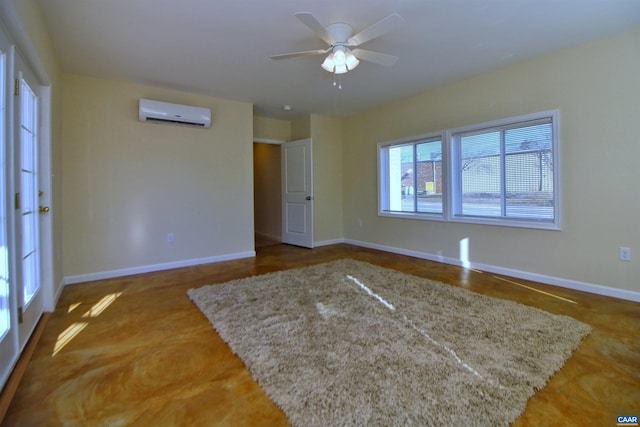 spare room featuring an AC wall unit and ceiling fan