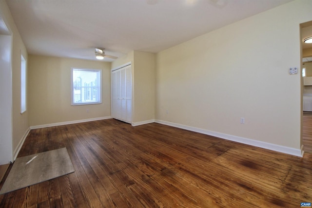 spare room with dark hardwood / wood-style floors and ceiling fan