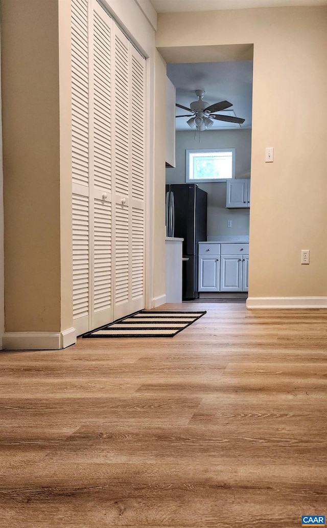 unfurnished living room with ceiling fan and light wood-type flooring