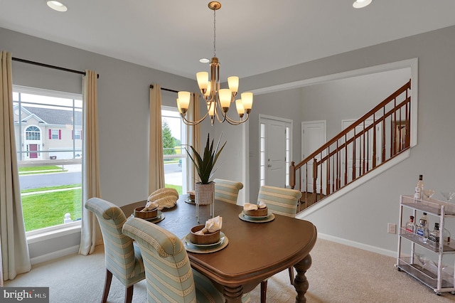 dining area with stairway, a notable chandelier, light colored carpet, and baseboards