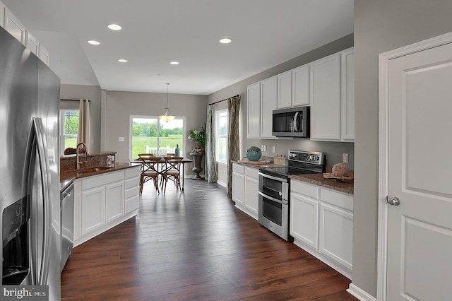 kitchen featuring recessed lighting, dark wood-style floors, white cabinets, stainless steel appliances, and a sink