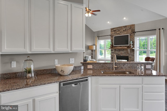 kitchen with a sink, open floor plan, white cabinetry, dishwasher, and ceiling fan