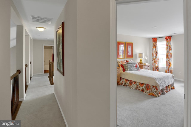 interior space featuring baseboards, visible vents, and carpet floors