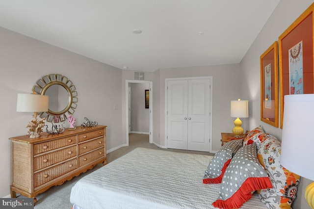 carpeted bedroom featuring baseboards, visible vents, and a closet