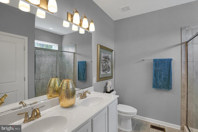 full bath with baseboards, visible vents, and a sink