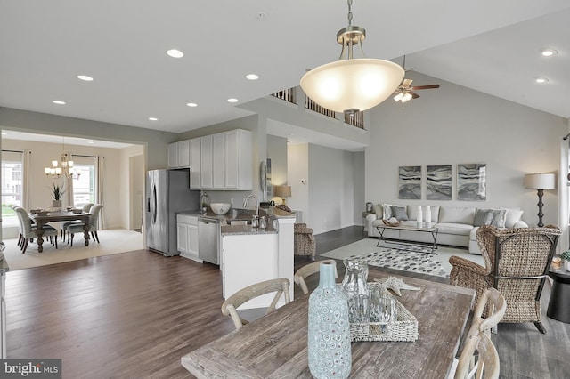 dining area featuring dark wood finished floors, recessed lighting, and ceiling fan with notable chandelier