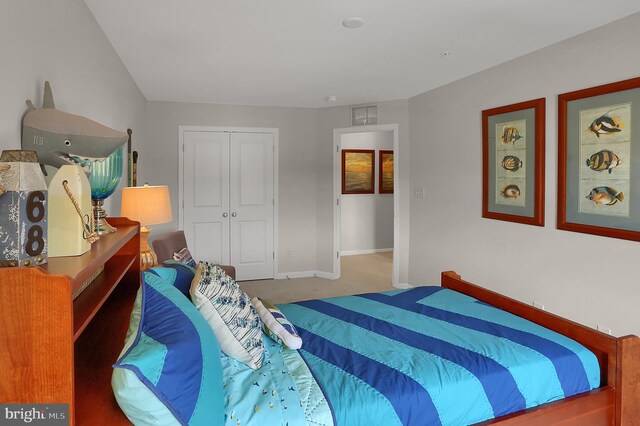 bedroom with a closet, visible vents, baseboards, and carpet