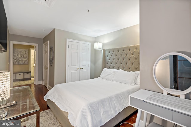 bedroom featuring dark hardwood / wood-style flooring and a closet