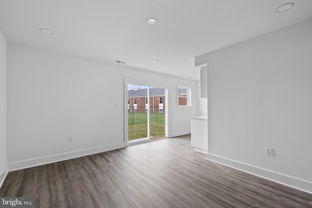 spare room featuring dark hardwood / wood-style flooring