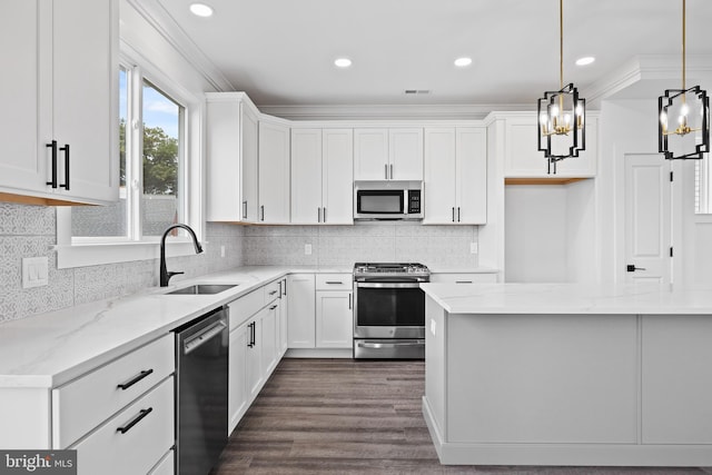 kitchen with visible vents, white cabinetry, stainless steel appliances, and a sink