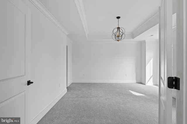 unfurnished room featuring baseboards, carpet floors, crown molding, a raised ceiling, and a notable chandelier