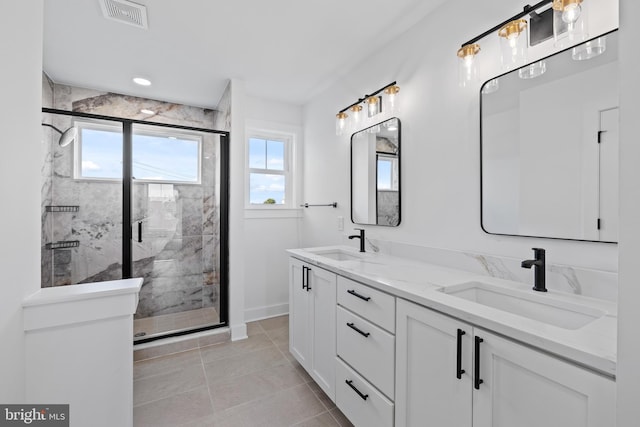 bathroom with plenty of natural light, visible vents, and a sink