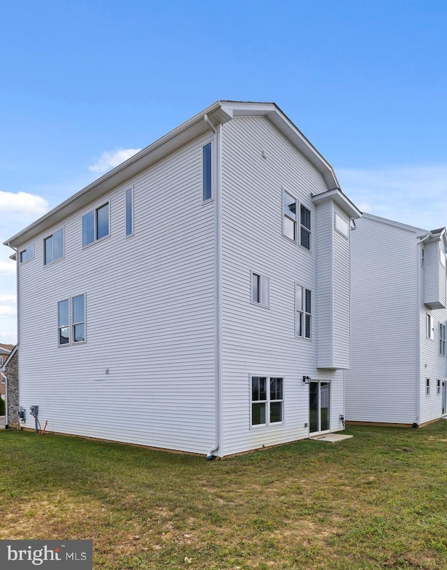 view of home's exterior featuring a yard