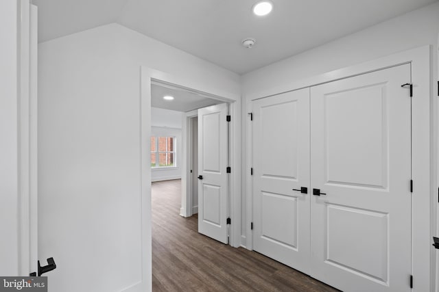 corridor with recessed lighting, dark wood-type flooring, and vaulted ceiling