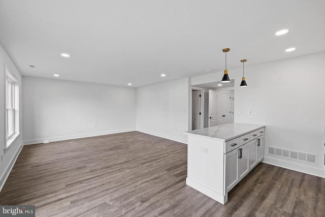 kitchen featuring visible vents, dark wood-type flooring, pendant lighting, recessed lighting, and light stone countertops