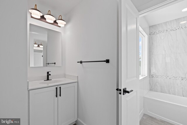 kitchen with stainless steel appliances, a kitchen island, white cabinetry, and sink