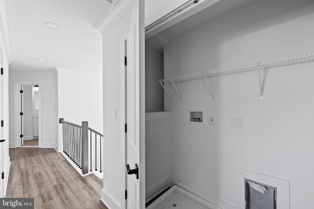 laundry room with wood finished floors, baseboards, laundry area, ornamental molding, and washer hookup