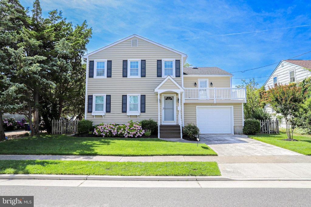 view of front of property with a front yard and a garage