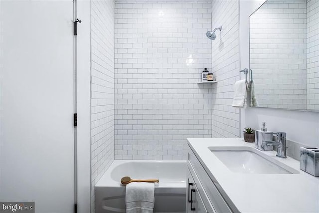 bathroom with vanity and tiled shower / bath combo