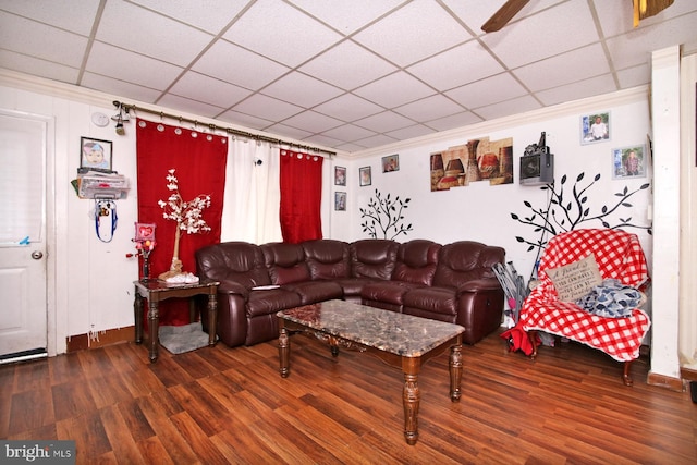 living room featuring dark hardwood / wood-style flooring and ornamental molding