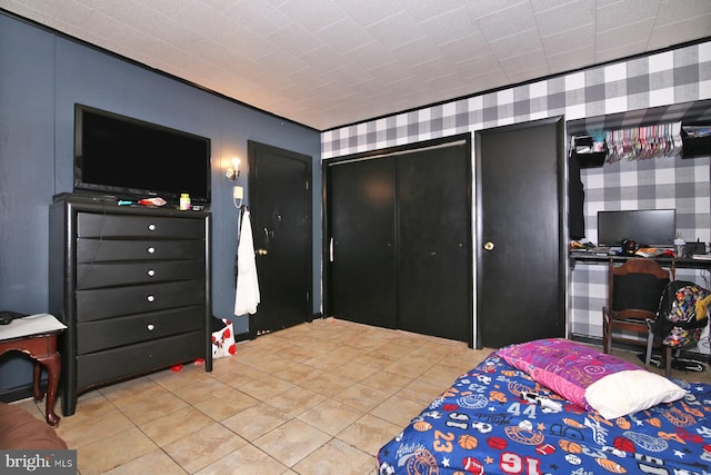 tiled bedroom with a closet