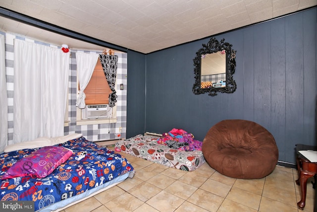 bedroom with wooden walls, tile patterned flooring, and cooling unit