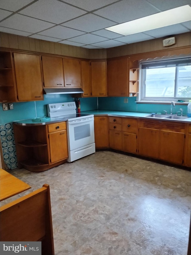 kitchen featuring electric range, a paneled ceiling, and sink