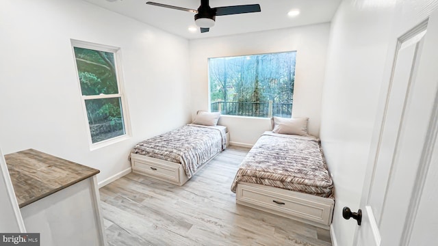 bedroom with light wood-type flooring and ceiling fan