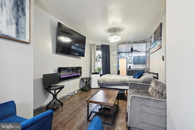 living room featuring dark hardwood / wood-style flooring and ceiling fan