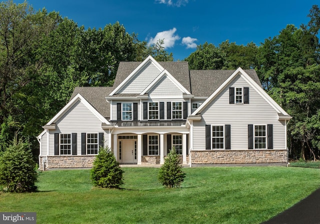 view of front facade with a front yard and a porch