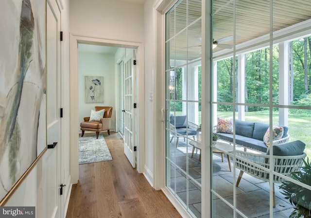 entryway featuring ceiling fan, french doors, and light hardwood / wood-style floors